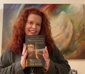 Lisa Rhyne holding her book, "Coming Out of The Metaphysical Closet"